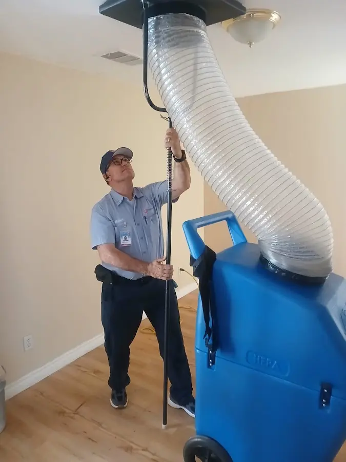 Furnace Tune-Up technician using HEPA equipment in Boston
