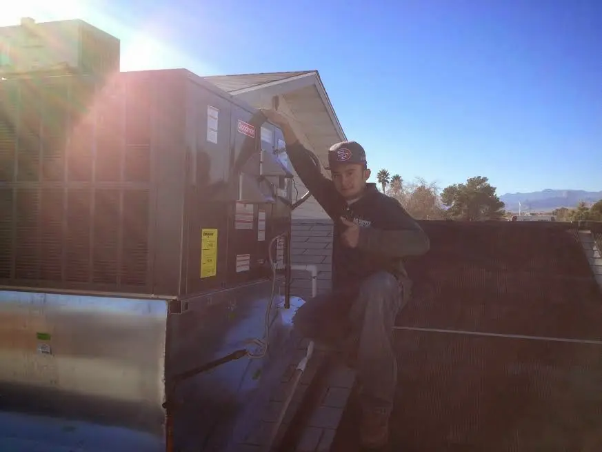 HVAC technician performing HVAC Inspection on a rooftop unit in Boston